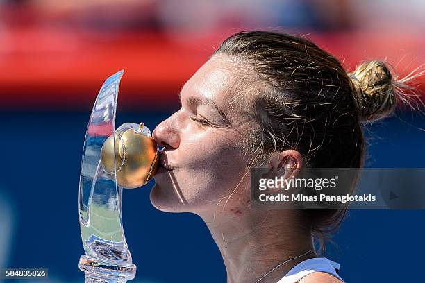 Simona Halep of Romania kisses the cup after defeating Madison Keys of the United States during day seven in final round action of the Rogers Cup at...