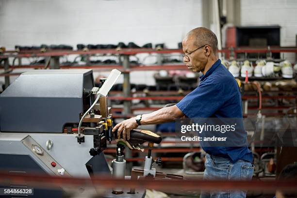 shoemaker working at a factory - shoe factory stock pictures, royalty-free photos & images