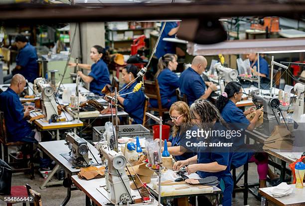 manual workers working at a factory - factory stockfoto's en -beelden