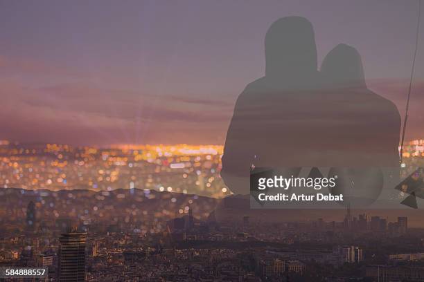 Couple contemplating Barcelona cityscape at night