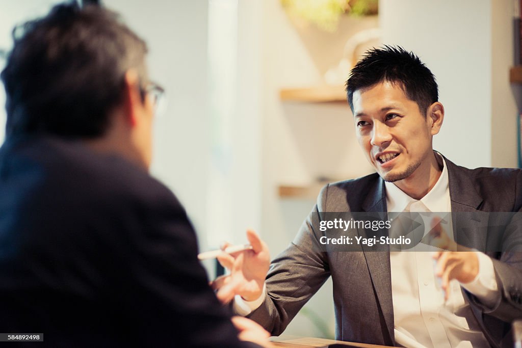 Two men in a casual meeting in a Cafe
