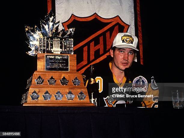 Canadian professional hockey player Mario Lemieux, forward for the Pittsburgh Penguins, pose with the Conn Smythe Trophy as the Pens celebrate their...