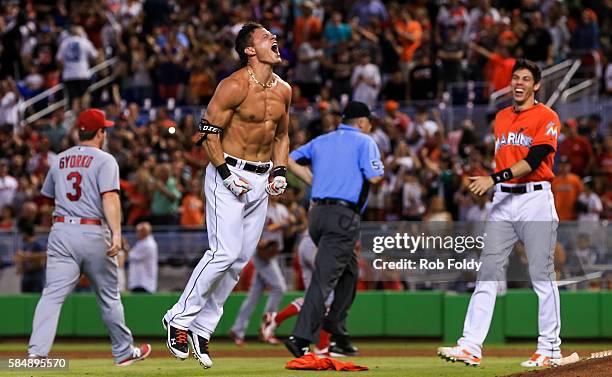 Derek Dietrich of the Miami Marlins celebrates after hitting a walk-off triple during the ninth inning of the game against the St. Louis Cardinals at...