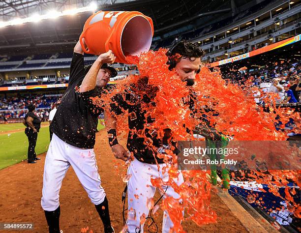 David Phelps dumps sports drink on Derek Dietrich after Dietrich hit a walk-off triple during the ninth inning to end the game against the St. Louis...