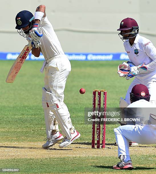 Virat Kohli of India blocks a shot off a delivery from West Indies bowler Roston Chase on day 2 of the 2nd Test between India and the West Indies on...