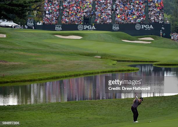 Branden Grace of South Africa plays a shot on the 18th hole after taking a drop during the final round of the 2016 PGA Championship at Baltusrol Golf...