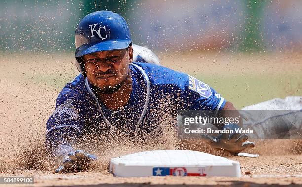 Jarrod Dyson of the Kansas City Royals steals third during the fifth inning of a baseball game against the Texas Rangers at Globe Life Park on...