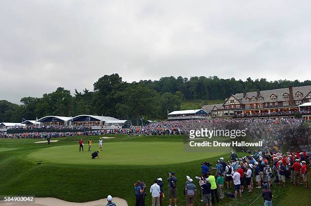 Jimmy Walker of the United States places his ball on the 18th green during the final round of the 2016 PGA Championship at Baltusrol Golf Club on...