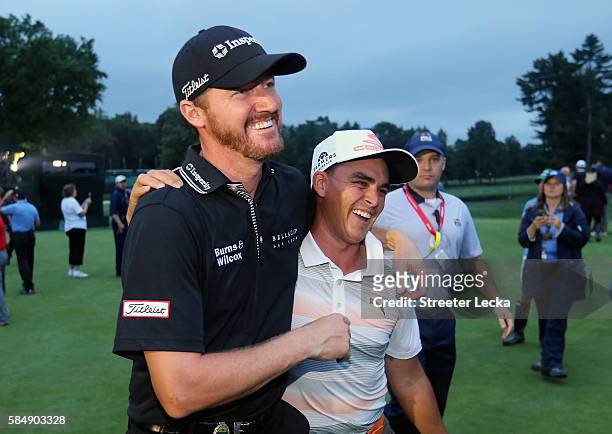 Jimmy Walker of the United States celebrates his victory with Rickie Fowler after the final round of the 2016 PGA Championship at Baltusrol Golf Club...