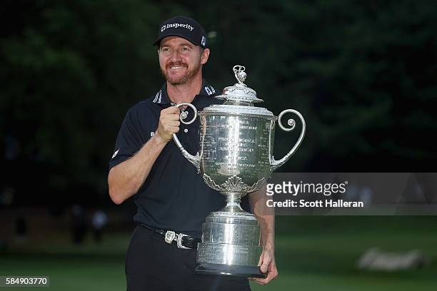 Jimmy Walker of the United States celebrates with the Wanamaker Trophy after winning the 2016 PGA Championship at Baltusrol Golf Club on July 31,...