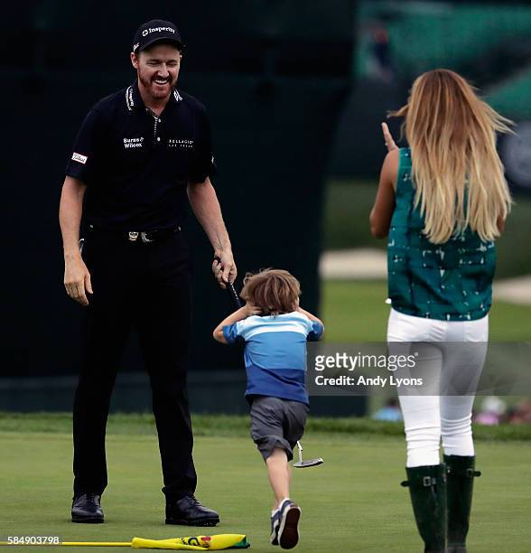 Jimmy Walker of the United States celebrates with his wife Erin and son Beckett after making par on the 18th hole to win the 2016 PGA Championship at...