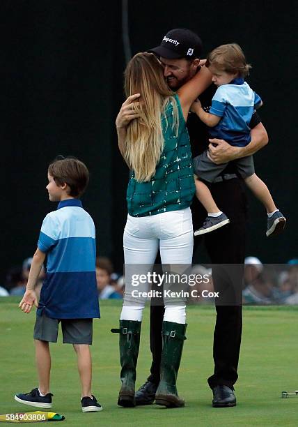 Jimmy Walker of the United States celebrates with his wife Erin and sons Beckett and Mclain after making par on the 18th hole to win the 2016 PGA...