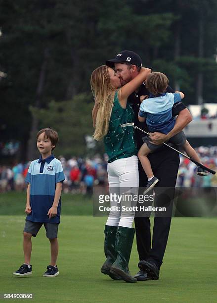 Jimmy Walker of the United States celebrates with his wife Erin and sons Beckett and Mclain after making par on the 18th hole to win the 2016 PGA...