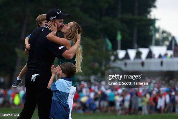 Jimmy Walker of the United States celebrates with his wife Erin and sons Beckett and Mclain after making par on the 18th hole to win the 2016 PGA...