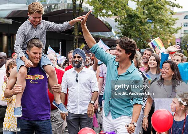 Oldest son Xavier James Trudeau high fives his dad Justin Trudeau Prime Minister of Canada while Ella-Grace Margaret Trudeau looks at her brother...