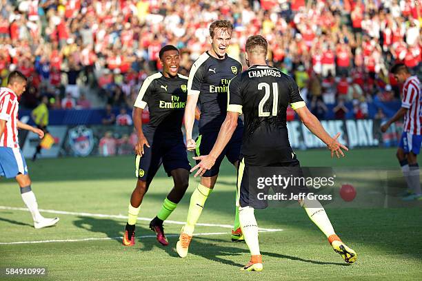 Alex Iwobi, Rob Holding and Calum Chambers of Arsenal celebrate Holding's first half goal against Chivas de Guadalajara at StubHub Center on July 31,...