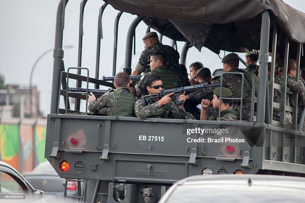 Brazilian Army truck passes by Complexo da Mare, a massive...