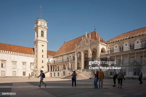 Visitors cross Patio das Escolas to admire the bell tower and Via Latina of Coimbra University, one of the oldest and illustrious universities and...