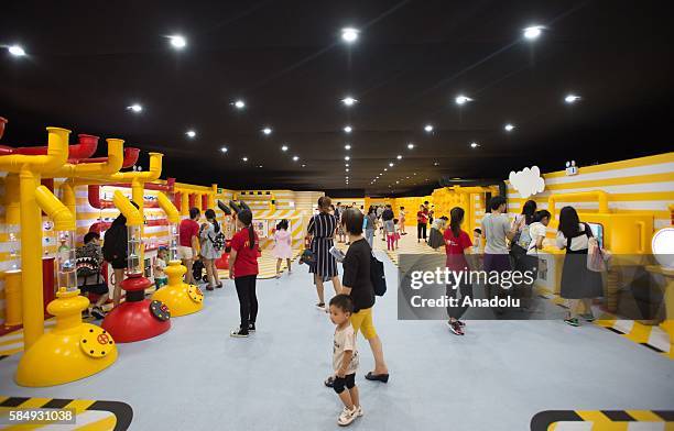 Visitors inspect the toys during the McDonald's toys exhibition at Canton Tower in Guangzhou, China on July 31, 2016 on the 25th anniversary of the...