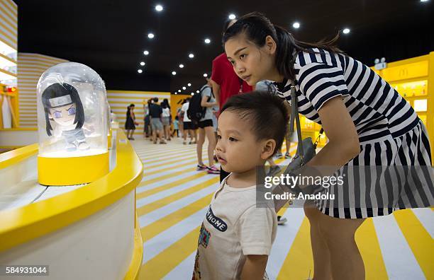 Visitors inspect the toys during the McDonald's toys exhibition at Canton Tower in Guangzhou, China on July 31, 2016 on the 25th anniversary of the...