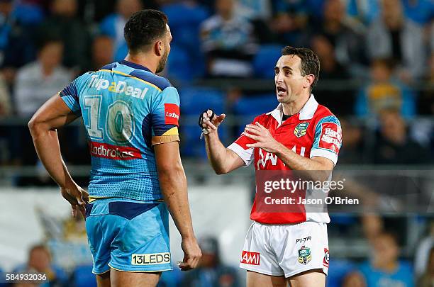 Referee Gerrard Sutton talks to Titans captain Ryan James during the round 21 NRL match between the Gold Coast Titans and the Cronulla Sharks at Cbus...