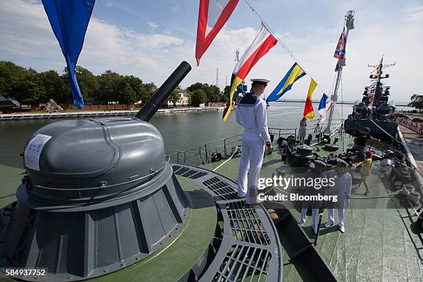 Russian sailors stand aboard the Parchim class corvette Kalmykia MPK 229 Baltic Fleet warship to supervise visitors during Russian Navy day at the...