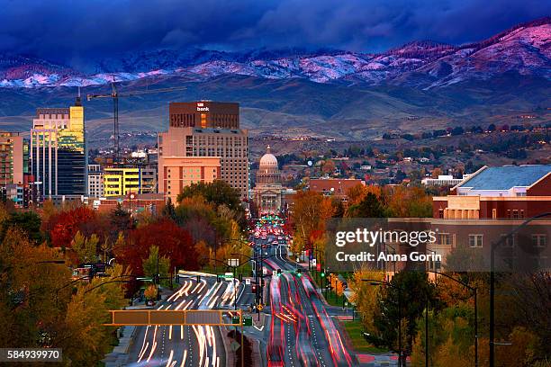downtown boise idaho at sunset with fresh snow on foothills, viewed from depot hill, long exposure - idaho fotografías e imágenes de stock