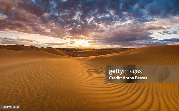 panorama of sunset in the desert - gobi desert stock-fotos und bilder