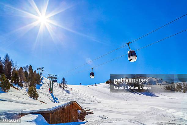 ski lifts and skiers on the dolomite alps - skipiste stockfoto's en -beelden