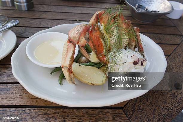 dungeness crab over potatoes and string beans - dungeness crab stock pictures, royalty-free photos & images