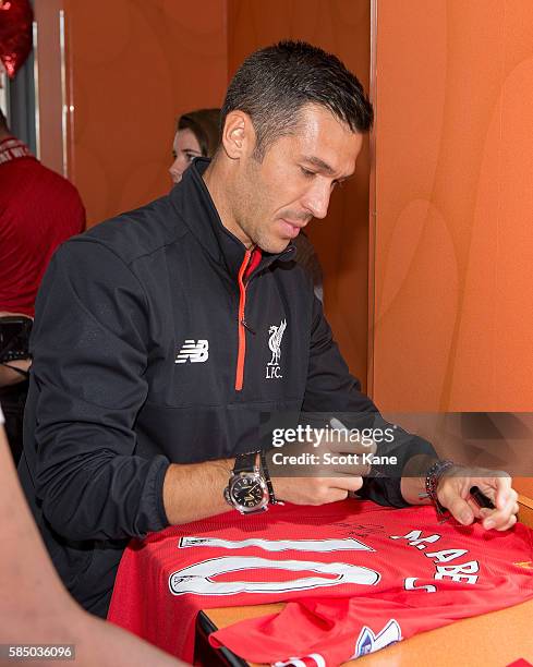 Luis Garcia ambassador of Liverpool signs an autograph during an appearance at the Kirkwood Dunkin' Donuts on August 1, 2016 in St. Louis, Missouri....