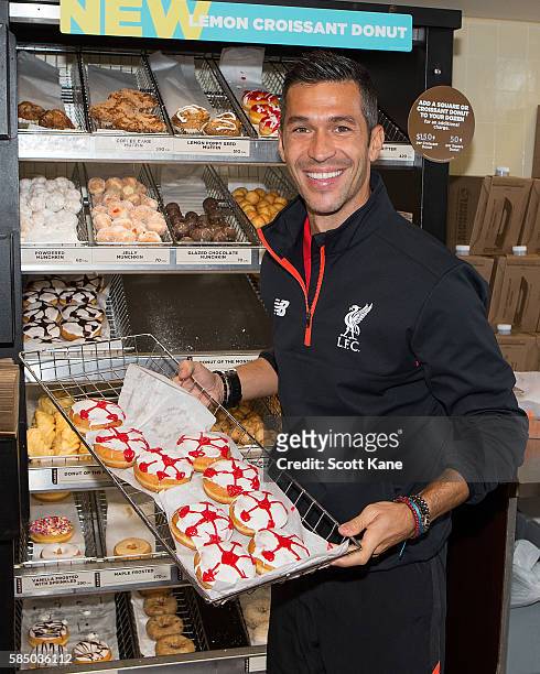 Luis Garcia ambassador of Liverpool shows off some freshly made donuts during an appearance at the Kirkwood Dunkin' Donuts on August 1, 2016 in St....