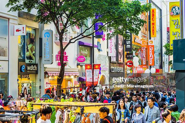 the famous shopping streets of myeong-dong - south korea stock pictures, royalty-free photos & images