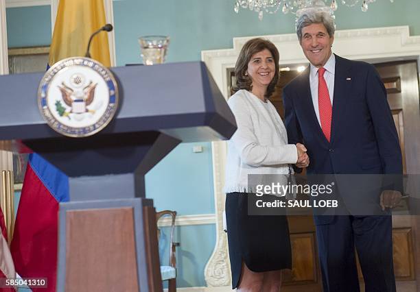 Secretary of State John Kerry shakes hands with Colombian Foreign Minister Maria Angela Holguin following a press conference at the State Department...
