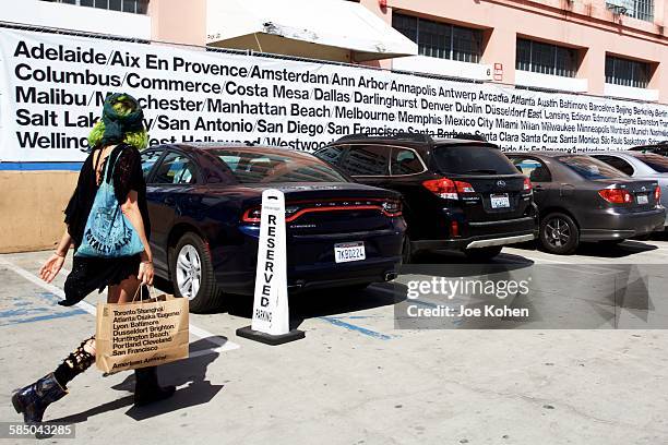 An American Apparel shopper walks with a shopping bag by the American Apparel factory and headquarters in downtown Los on October 5, 2015. American...