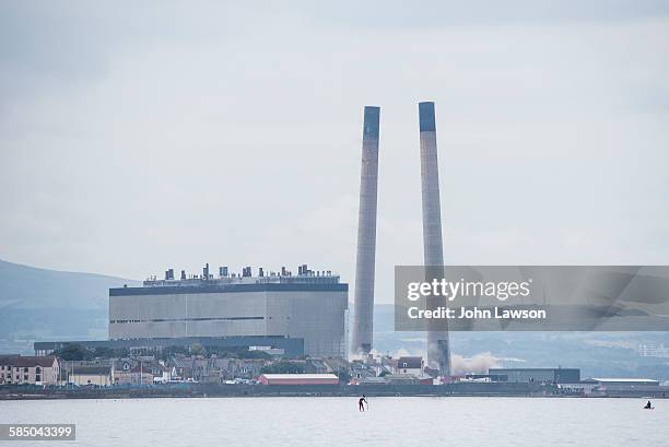 The iconic chimneys at Cockenzie Power Station, one of the few remaining coal-fired UK power stations, are demolished. The power station is near...