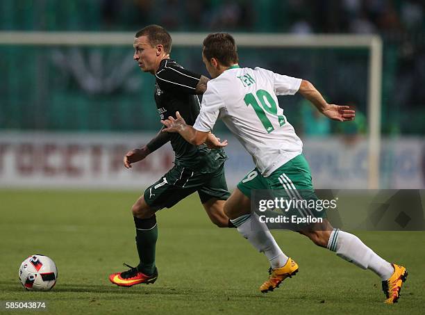 Pavel Mamaev of FC Krasnodar is challenged by Peter Chung of FC Tom Tomsk during the Russian Premier League match between FC Krasnodar v FC Tom Tomsk...