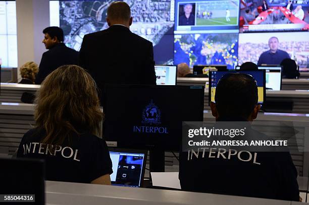 Interpol officers work at the International Police Cooperation Center in Brasilia, on August 1 during its inauguration. The centre will work during...