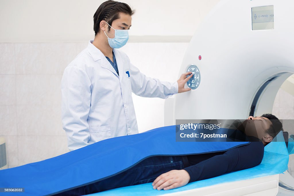 Radiologist with a patient at MRI scan