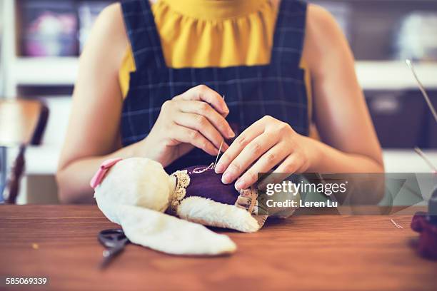 woman sewing stuffed animal - chinese dolls stock pictures, royalty-free photos & images