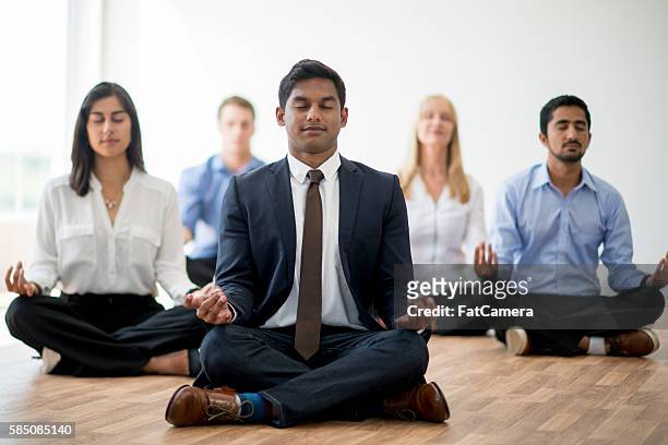 business professionals meditating together - bussines group suit tie stock pictures, royalty-free photos & images