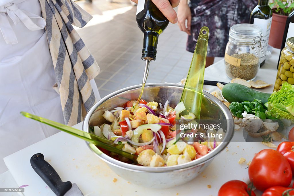 Caucasian man preparing food (salad cooking lesson)