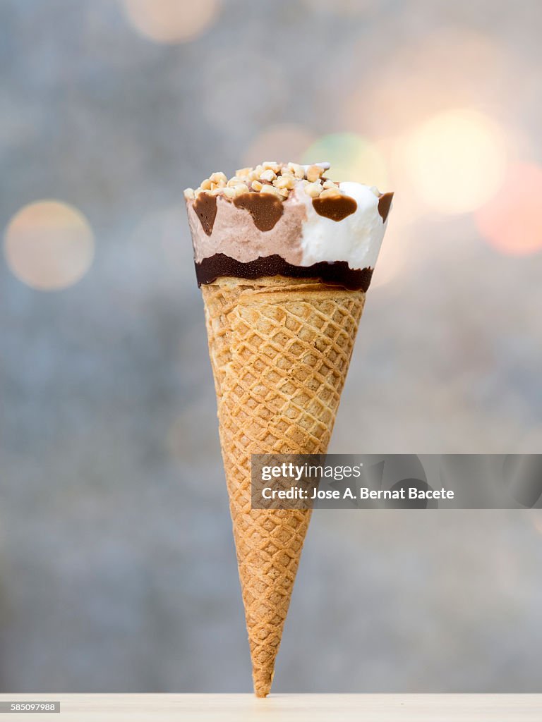 Cone ice cream and chocolate with nuts, illuminated by sunlight
