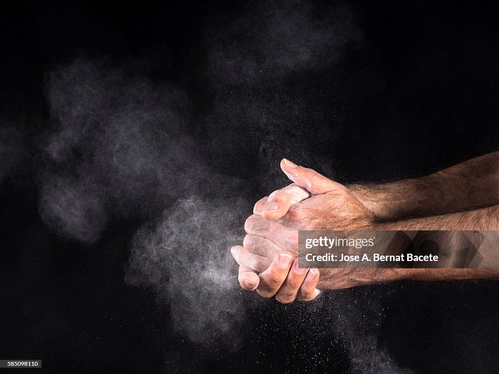 Dirty hands of a man, covered with dust, slapping