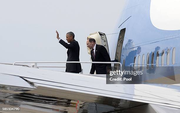 President Barack Obama and Secretary of Veterans Affairs Robert A. McDonald walk down the stairs of Air Force One as he returns from Atlanta, Georgia...