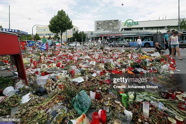 With flowers, candles and personal messages people express their grief for the victims of last weeks shooting spree that left nine victims dead on...