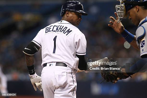 Tim Beckham of the Tampa Bay Rays looks back at catcher Salvador Perez of the Kansas City Royals after striking out swinging to end the fifth inning...