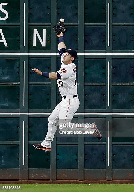 Preston Tucker of the Houston Astros has a line drive by Devon Travis of the Toronto Blue Jays go off the top of his glove in the third inning for a...