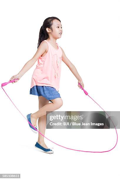 happy girl jumping rope - touwtje springen stockfoto's en -beelden