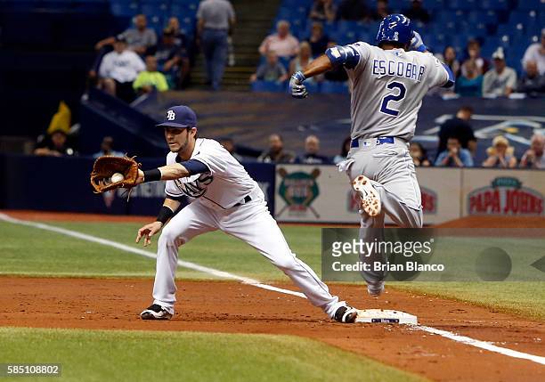 First baseman Nick Franklin of the Tampa Bay Rays hauls in the throw from third baseman Evan Longoria of the Tampa Bay Rays for the out at first on...